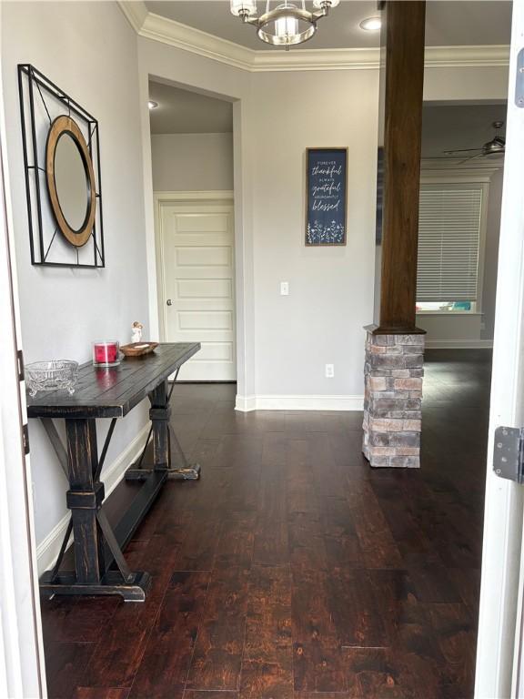 773 Via Firenze Ave, Tontitown, AR 72762 - hall featuring decorative columns, baseboards, crown molding, wood-type flooring, and a chandelier