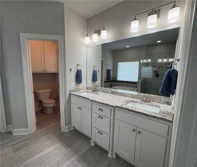 773 Via Firenze Ave, Tontitown, AR 72762 - full bathroom featuring a stall shower, a garden tub, toilet, double vanity, and baseboards