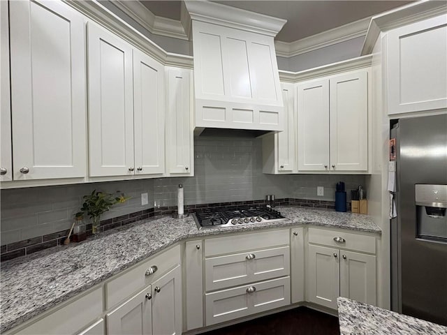 773 Via Firenze Ave, Tontitown, AR 72762 - kitchen with stainless steel appliances, white cabinets, decorative backsplash, and ornamental molding