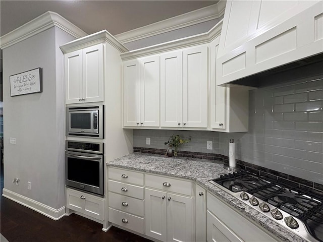 773 Via Firenze Ave, Tontitown, AR 72762 - kitchen with stainless steel appliances, backsplash, baseboards, white cabinetry, and light stone counters