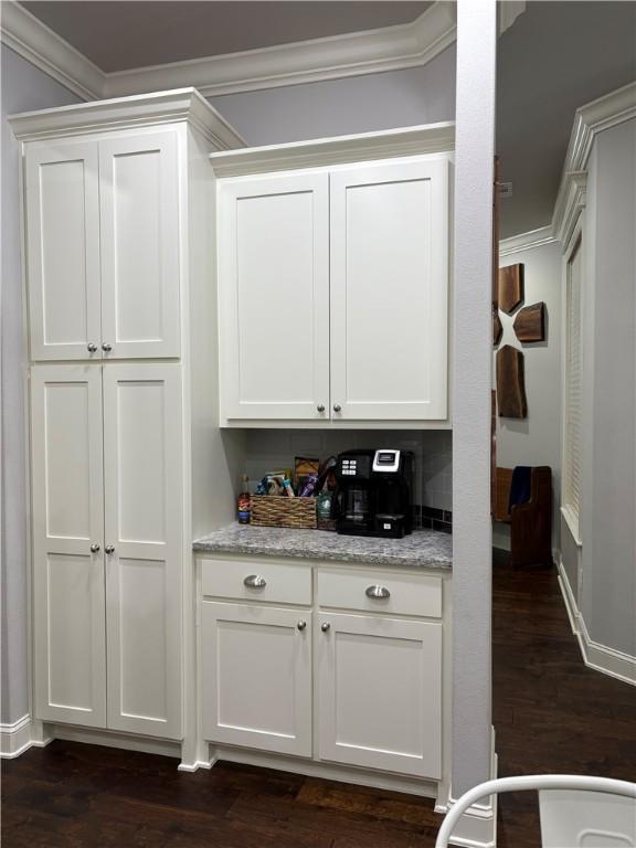 773 Via Firenze Ave, Tontitown, AR 72762 - bar with ornamental molding, dark wood-type flooring, and baseboards