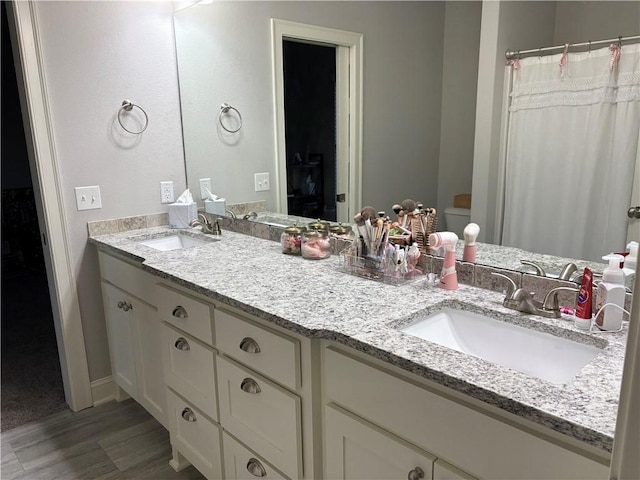 773 Via Firenze Ave, Tontitown, AR 72762 - bathroom with wood finished floors, double vanity, baseboards, and toilet