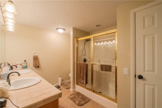 18880 Skylight Mountain Rd, Canehill, AR 72717 - full bath with a shower stall, a textured ceiling, double vanity, and tile patterned floors