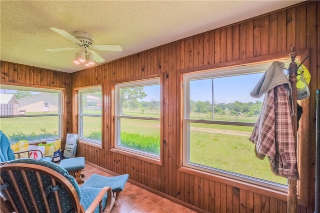18880 Skylight Mountain Rd, Canehill, AR 72717 - sunroom featuring a textured ceiling, tile patterned floors, and wood walls
