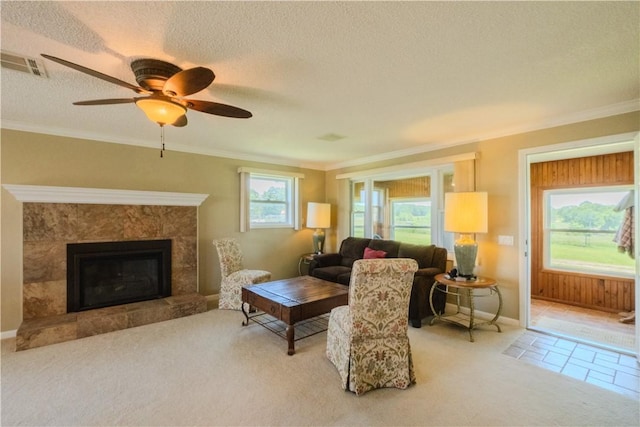 18880 Skylight Mountain Rd, Canehill, AR 72717 - carpeted living area featuring a textured ceiling, crown molding, a tiled fireplace, ceiling fan, and baseboards