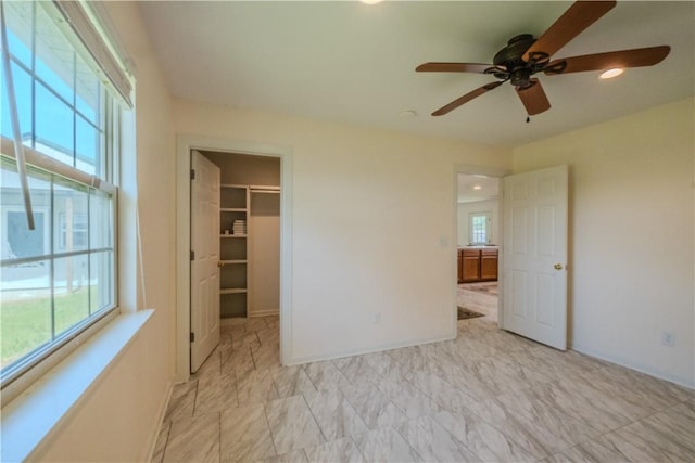 18880 Skylight Mountain Rd, Canehill, AR 72717 - unfurnished bedroom featuring a walk in closet, recessed lighting, a closet, and a ceiling fan