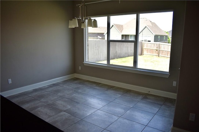 2402 N Brook Ln, Siloam Springs, AR 72761 - unfurnished dining area with baseboards, tile patterned flooring, and a chandelier