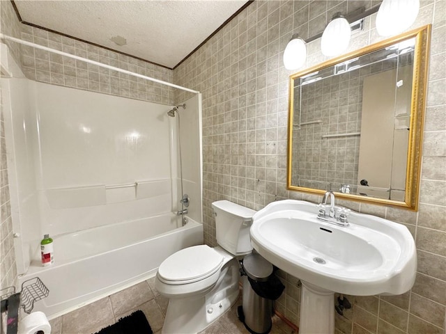 505 10th St, Bentonville, AR 72712 - bathroom with tile walls, a textured ceiling,  shower combination, and toilet