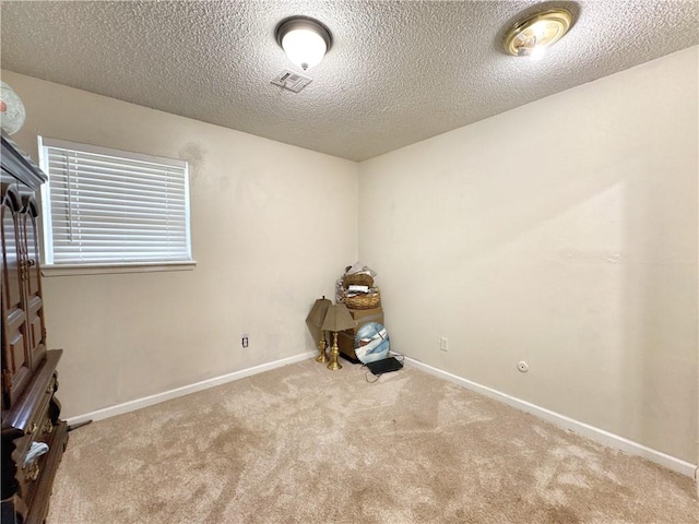 505 10th St, Bentonville, AR 72712 - spare room featuring carpet flooring, a textured ceiling, and baseboards