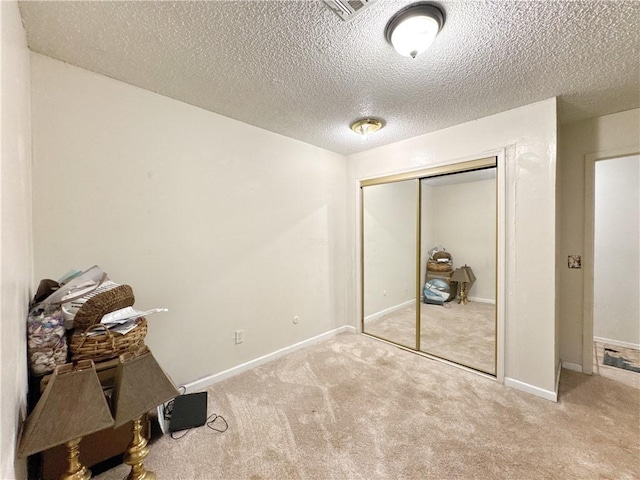 505 10th St, Bentonville, AR 72712 - unfurnished bedroom with carpet, a textured ceiling, a closet, and baseboards