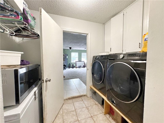 505 10th St, Bentonville, AR 72712 - washroom featuring washing machine and dryer, a textured ceiling, light tile patterned floors, and cabinet space