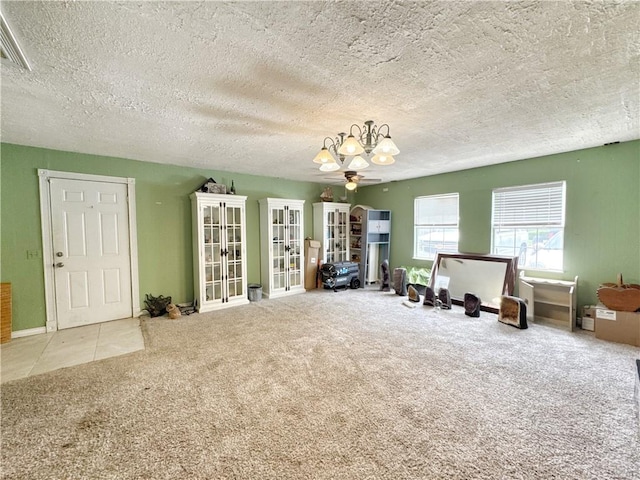 505 10th St, Bentonville, AR 72712 - living area featuring a chandelier, french doors, carpet, a textured ceiling, and baseboards