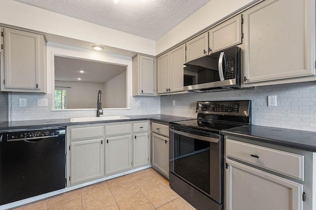 16 Eleanor Ln, Bella Vista, AR 72714 - kitchen with appliances with stainless steel finishes, a sink, dark countertops, tasteful backsplash, and light tile patterned floors