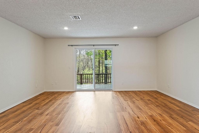 16 Eleanor Ln, Bella Vista, AR 72714 - empty room featuring a textured ceiling, wood finished floors, baseboards, and recessed lighting