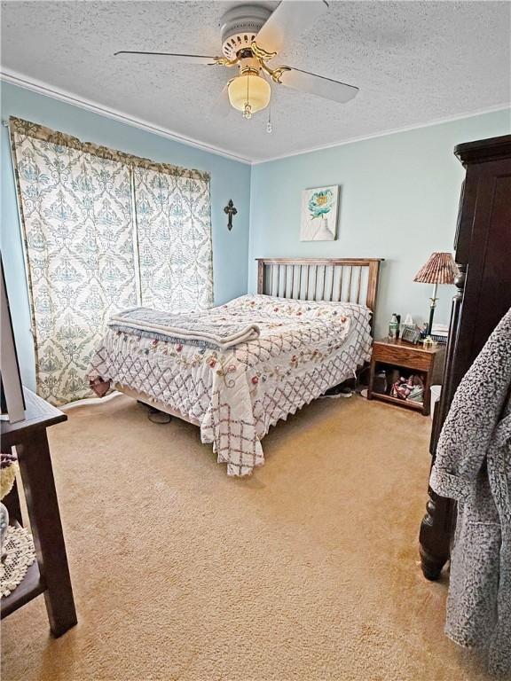 1711 W Cline Rd, Clarksville, AR 72830 - carpeted bedroom with a textured ceiling, crown molding, and ceiling fan