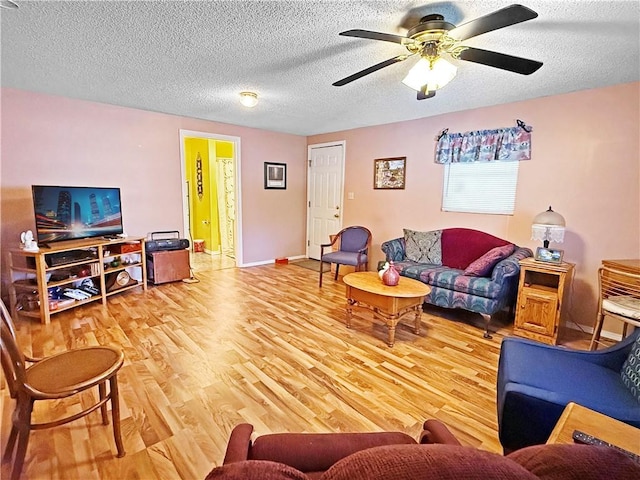1711 W Cline Rd, Clarksville, AR 72830 - living room featuring ceiling fan, wood finished floors, a textured ceiling, and baseboards