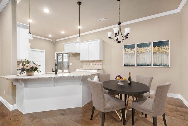 506 Hindman Dr, Prairie Grove, AR 72753 - dining area with ornamental molding, baseboards, a chandelier, recessed lighting, and wood finished floors