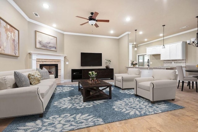 506 Hindman Dr, Prairie Grove, AR 72753 - living room with a ceiling fan, ornamental molding, light wood-type flooring, a tiled fireplace, and recessed lighting