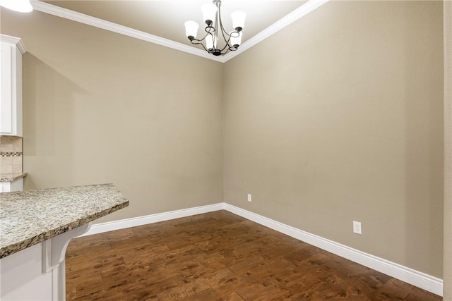 506 Hindman Dr, Prairie Grove, AR 72753 - unfurnished dining area featuring crown molding, a chandelier, baseboards, and dark wood-style floors