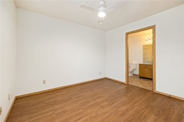 413 Columbia Pl, Lowell, AR 72745 - unfurnished room with light wood finished floors, a ceiling fan, and baseboards