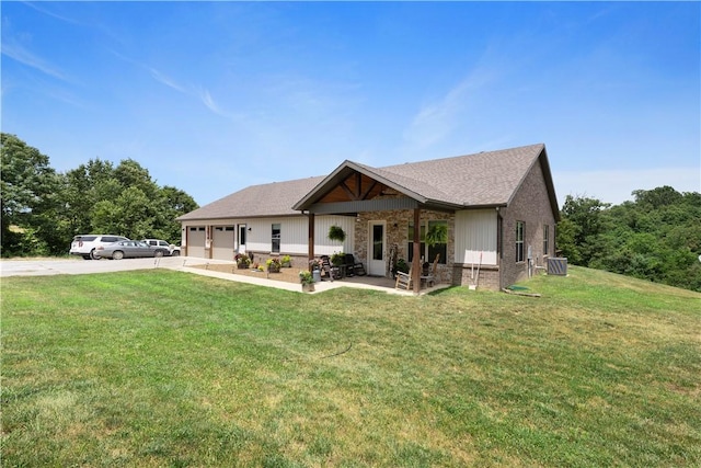 13812 Sunburst Ln, Gravette, AR 72736 - view of front of house featuring driveway, a garage, a front yard, central AC unit, and brick siding