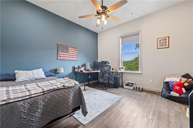 13812 Sunburst Ln, Gravette, AR 72736 - bedroom with wood finished floors, baseboards, an office area, and a ceiling fan