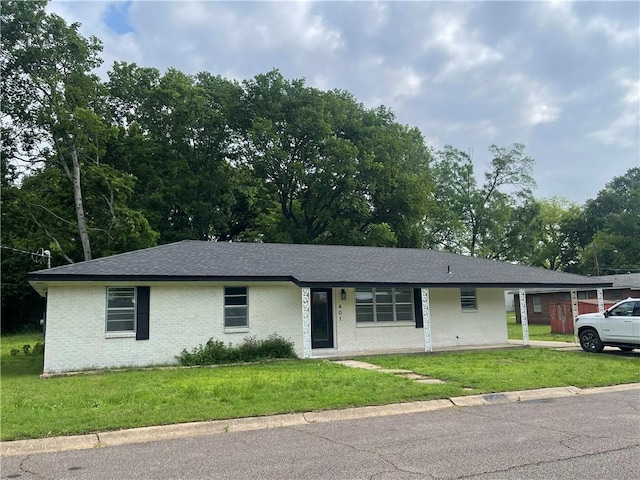 401 Walnut St, Clarksville, AR 72830 - ranch-style home with brick siding, a front yard, and roof with shingles