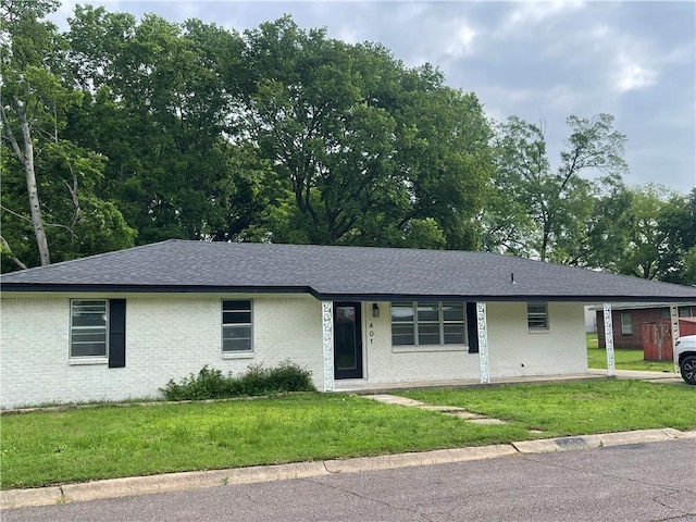 401 Walnut St, Clarksville, AR 72830 - ranch-style home featuring a shingled roof, a front lawn, and brick siding