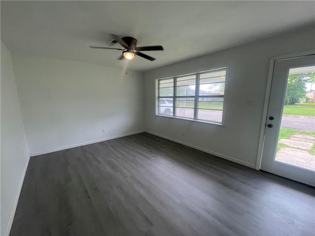 401 Walnut St, Clarksville, AR 72830 - unfurnished living room with a ceiling fan, dark wood-style flooring, and baseboards