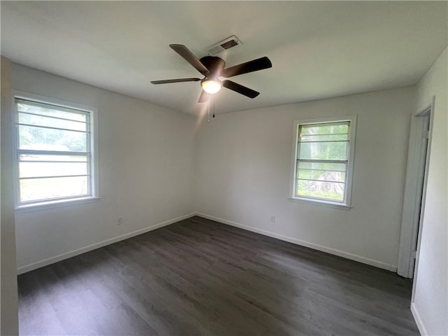 401 Walnut St, Clarksville, AR 72830 - unfurnished room featuring plenty of natural light, dark wood finished floors, and ceiling fan