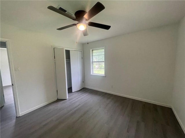 401 Walnut St, Clarksville, AR 72830 - unfurnished bedroom with dark wood finished floors, a closet, and a ceiling fan
