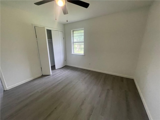 401 Walnut St, Clarksville, AR 72830 - unfurnished bedroom featuring baseboards, dark wood-type flooring, and a closet