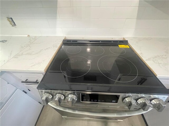 401 Walnut St, Clarksville, AR 72830 - kitchen view of range with electric stovetop and light stone counters