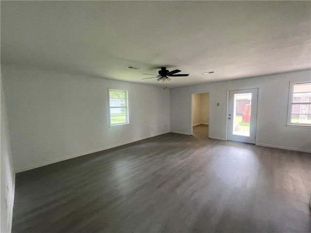 401 Walnut St, Clarksville, AR 72830 - empty room with dark wood finished floors, ceiling fan, and baseboards