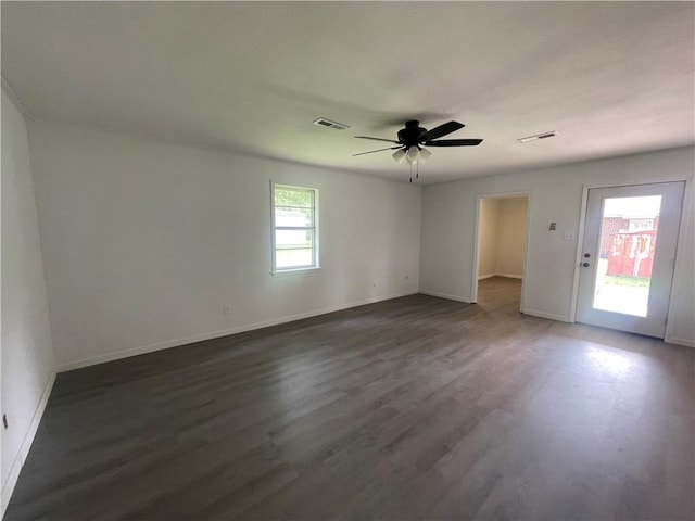 401 Walnut St, Clarksville, AR 72830 - spare room featuring dark wood finished floors, ceiling fan, and baseboards