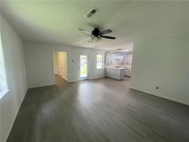 401 Walnut St, Clarksville, AR 72830 - unfurnished living room featuring baseboards, ceiling fan, and wood finished floors