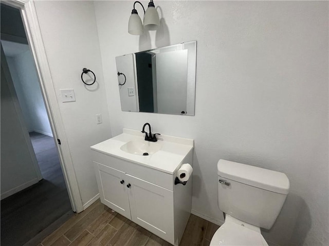 401 Walnut St, Clarksville, AR 72830 - half bath with wood finished floors, vanity, toilet, and baseboards