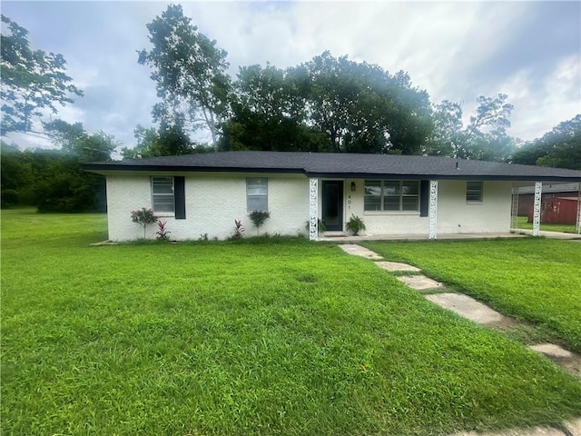 401 Walnut St, Clarksville, AR 72830 - single story home with a front yard, a carport, and brick siding
