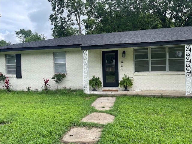 401 Walnut St, Clarksville, AR 72830 - ranch-style house with a front lawn, roof with shingles, brick siding, and covered porch