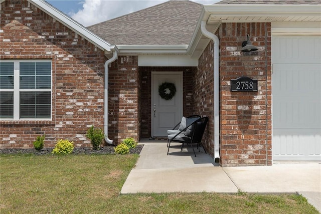 2758 Suncrest Ave, Springdale, AR 72764 - property entrance featuring brick siding, roof with shingles, a yard, and an attached garage