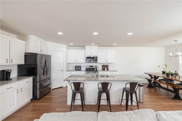 2758 Suncrest Ave, Springdale, AR 72764 - kitchen with appliances with stainless steel finishes, a sink, a breakfast bar, white cabinetry, and recessed lighting