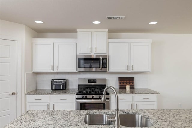 2758 Suncrest Ave, Springdale, AR 72764 - kitchen featuring appliances with stainless steel finishes, a sink, white cabinetry, and recessed lighting
