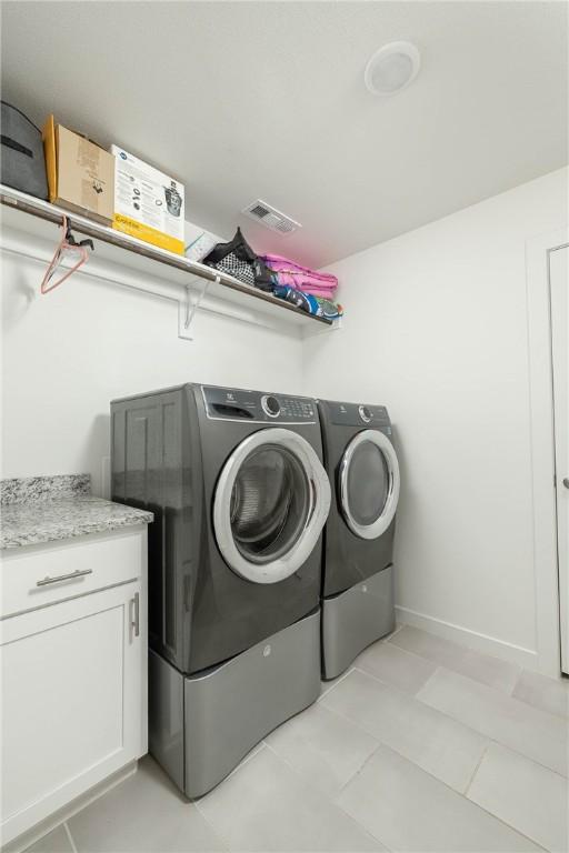 2758 Suncrest Ave, Springdale, AR 72764 - clothes washing area with washing machine and clothes dryer and light tile patterned floors