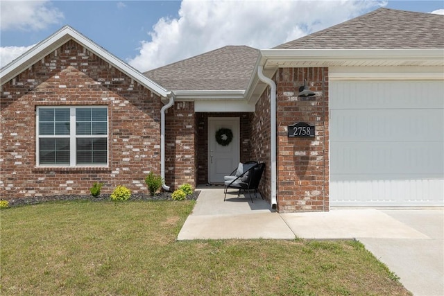 2758 Suncrest Ave, Springdale, AR 72764 - view of exterior entry featuring a shingled roof, a yard, brick siding, an attached garage, and concrete driveway