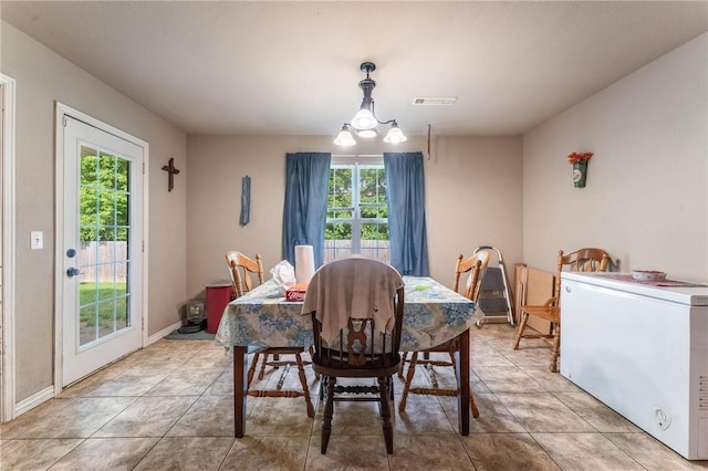 1329 Homestead Ln, West Fork, AR 72774 - dining room featuring a chandelier, light tile patterned flooring, and baseboards