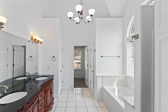 1878 Morning Side Falls Blvd, Blue Eye, MO 65611 - bathroom featuring tile patterned floors, a bath, a chandelier, double vanity, and baseboards