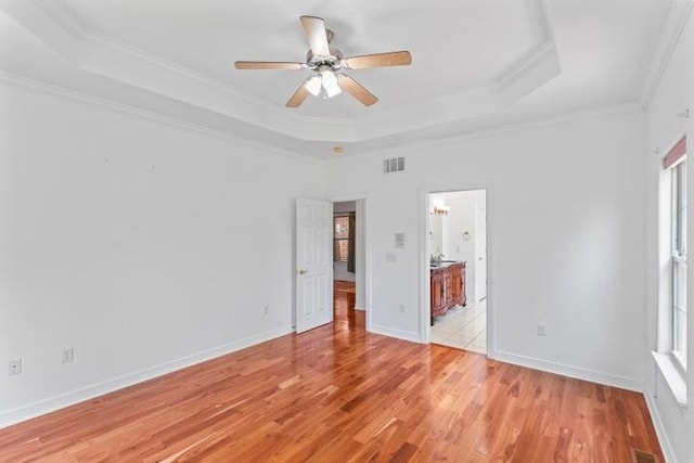 1878 Morning Side Falls Blvd, Blue Eye, MO 65611 - unfurnished bedroom with a raised ceiling, crown molding, light wood finished floors, ensuite bath, and baseboards