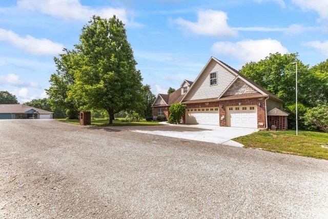 1878 Morning Side Falls Blvd, Blue Eye, MO 65611 - traditional home featuring brick siding, driveway, and an attached garage