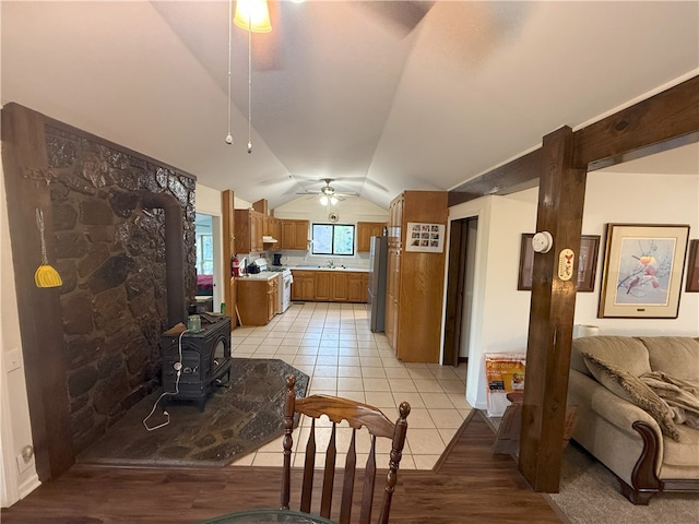 1088 Little Red River Rd, Leslie, AR 72645 - kitchen with ceiling fan, a wood stove, white range with gas stovetop, freestanding refrigerator, and light countertops