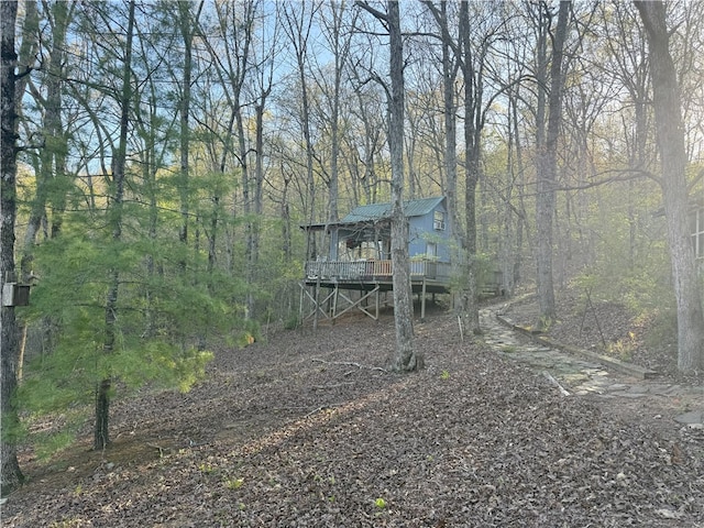 1088 Little Red River Rd, Leslie, AR 72645 - view of front of home with a wooden deck, metal roof, and a wooded view
